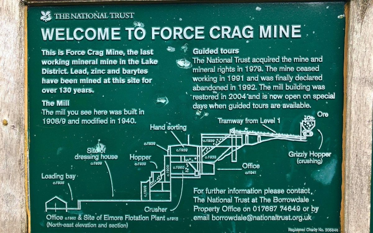 Close up view of a green National Trust information board detailing the history and layout of Force Crag Mine.