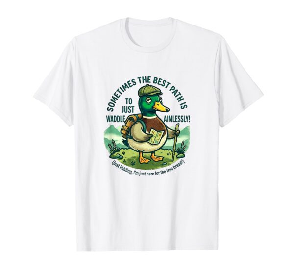 A black t-shirt mockup with a cartoon graphic of a mallard duck wearing a beanie and hiking backpack, with curved text that reads "WADDLE AIMLESSLY AROUND THE LAKE DISTRICT."