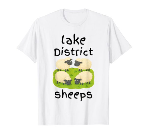 A white t-shirt featuring a cute cartoon illustration of four sheep grazing on a green patch of grass, with the text 'lake District' above and the playful, intentional misspelling 'sheeps' written below.