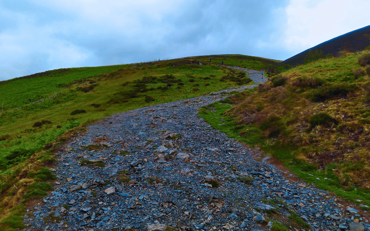 Steep loose slate and stone hiking path leading up Jenkin Hill on the Skiddaw mountain trail in Keswick, Lake District
